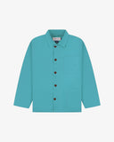 Front flat shot of aqua-blue, buttoned organic cotton overshirt. Clear view of chest and hip pockets, corozo buttons and Uskees branding label.