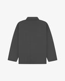 Reverse of charcoal-grey buttoned organic cotton drill overshirt from Uskees. Showing reinforced elbows and boxy silhouette.
