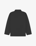 Back view of charcoal-grey, buttoned organic cotton overshirt with view of reinforced elbow area and boxy silhouette.