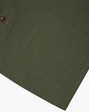 Closer view of mid section of coriander-green, buttoned organic cotton overshirt from Uskees. Focus on hem, pockets and corozo buttons.