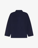 Reverse of deep indigo buttoned organic cotton corduroy overshirt from Uskees. Showing reinforced elbows and boxy silhouette.