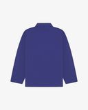 Back view of ultra blue, buttoned organic cotton overshirt with view of reinforced elbow area and boxy silhouette.