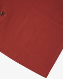 Close-up of a clay red pocket on an Uskees Men's Shacket with a white background