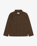 Front flat shot of an Uskees brown linen overshirt for men showing the 3 front pockets.