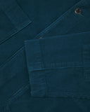 Close-up view of cuff, placket and corozo buttons of organic corduroy, petrol blue blazer from Uskees.