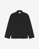 Flat front view of knitted organic cotton charcoal-grey blazer with 3 patch pockets from Uskees. Clearly showing corozo buttons, two branding labels and 3 pockets on the front.