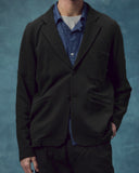 Closer view wearing the #3044 knitted blazer in charcoal-grey. One button secured, showing the looser silhouette.