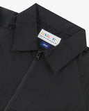 Close up view of Uskees black ripstop field jacket with focus on the collar, zipper, hanging hook and branding label.