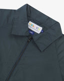Close up view of Uskees blueberry ripstop field jacket with focus on the collar, zipper, hanging hook and branding label.