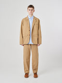 Front view of male model wearing the Uskees 3047 Docklands khaki blazer unbuttoned, paired with matching Uskees pants.