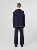 Back view of male model wearing the Uskees 3047 Docklands midnight blue blazer with view of back vent.