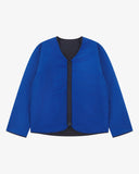 Front view of Uskees Evo liner jacket reversed showing the bright blue reversable lining and the chest and twin wax welt pockets.