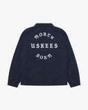 Back view flat shot of Uskees navy blue coach jacket for men with focus on the the North Born Uskees slogan, straight-cut hem and elasticated cuffs.
