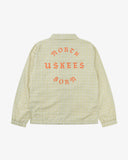 Back view flat shot of Uskees pastel yellow check coach jacket for men with focus on the the North Born Uskees slogan, straight-cut hem and elasticated cuffs.