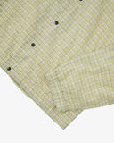Close up shot of Uskees pastel yellow check coach jacket for men showing the elasticated cuff and black poppers.