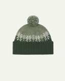 Front view of Uskees 4012 'coriander' lambswool snowflake hat, with a clear view of the coriander, pale green and white colourway, snowflake motif and bobble.