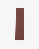 Neatly folded Donegal Merino wool scarf in a speckled brick red colourway.