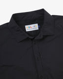 Close-up front view of black Technique trekking shirt for men showing the collar area with front ticket pocket, branding label and hanging loop.
