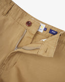 Close-up front view of the organic twill khaki 'painter' trousers showing belt loops, zip fly, branding label and Corozo button.