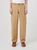 Close-up front view modelling 5021 Uskees men's organic twill khaki painter pants highlighting relaxed, flattering fit.