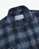 Close view of an Uskees navy check long sleeved flannel shirt for men showing the collar detail.
