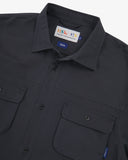 Close up view of an Uskees dark blue long sleeved shirt for men showing the chest pockets and collar detail.