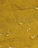 Magnified view of the dry waxed fabric, demonstrating the material's water repellent properties.