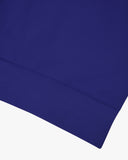 Closer view view of the discreet brand logo on ribbed hem of the Uskees vibrant blue organic heavyweight cotton 7005 jersey sweatshirt.