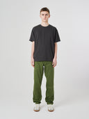 Full-length view of model wearing 7006 faded black organic cotton t-shirt, demonstrating loose fit.