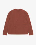 Full flat view of the Uskees chestnut brown organic cotton long-sleeve T-shirt for men, showing the breast pocket, mini branding label and loose silhouette.