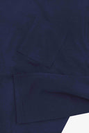 Closer look at the chest pocket and cuff of the dark indigo organic cotton long sleeve T-shirt showing texture of the medium weight organic cotton jersey.