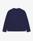 Full flat view of the Uskees dark indigo organic cotton long-sleeve T-shirt for men, showing the breast pocket, mini branding label and loose silhouette.