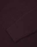 Close up view of an Uskees dark red crew knit men's jumper showing the sleeve and cuff detail.