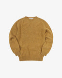 Front flat view of speckled butterscotch, Alderney crew neck jumper in Scottish new wool. Clear view of drop shoulder design Uskees branding label.