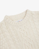 Close up view of Uskees cream-coloured men's chunky cable knit jumper showing the neck detail.